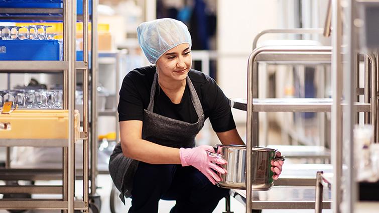 Kesätyötä tekevä nuori keittiötyössä. 